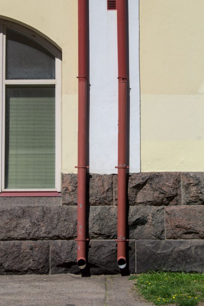 Two downspouts on a building wall