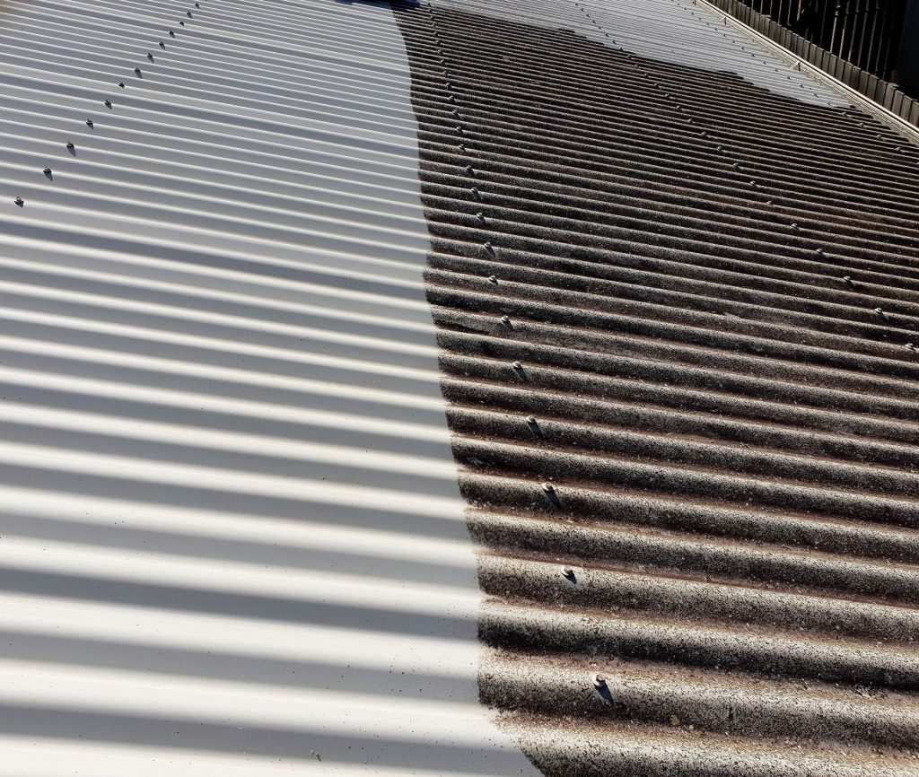 Metal roof with the cleaned section on the left and the untreated section on the right
